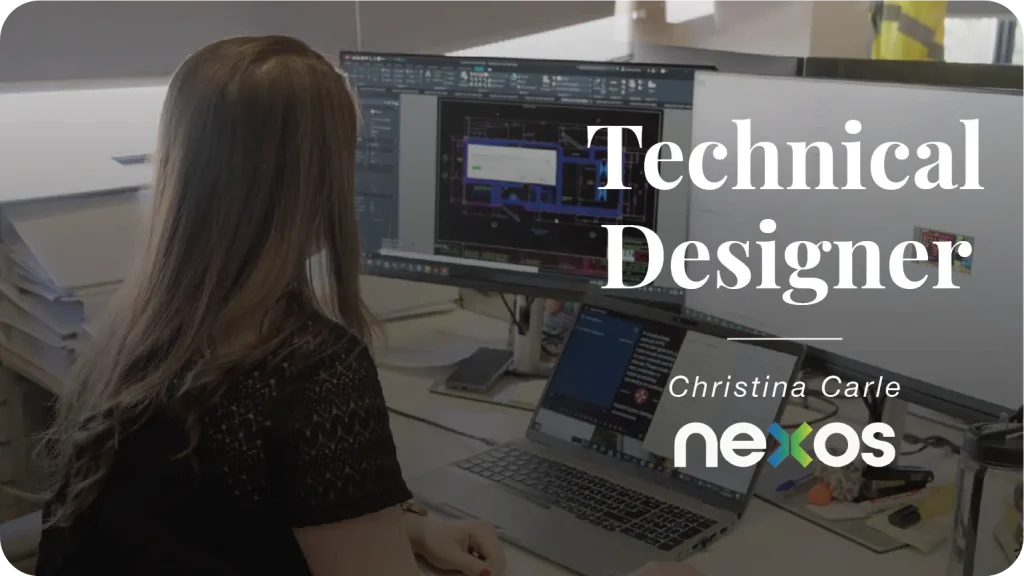 a woman who is a technical designer looking at a computer monitor