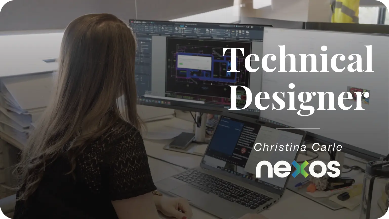 a woman who is a technical designer looking at a computer monitor